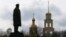 Ukraine -- A view shows a statue of Soviet state founder Vladimir Lenin in front of a cathedral in a street in Slovyansk, April 14, 2014