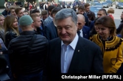 Incumbent President Petro Poroshenko speaks to RFE/RL as he arrives at Kyiv's House of Officers to cast his ballot with his wife, Maryna Poroshenko, on April 21.