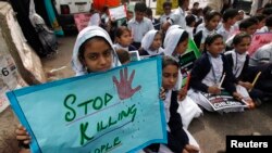 Students protest for the victims of the school massacre in Peshawar on December 19.