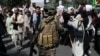 A Taliban soldier in combat gear stands amid protesters during an anti-Pakistan protest in Kabul on September 7.