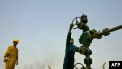 Workers carry out checks at the Kirkuk oil field.