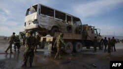 Taliban militants have stepped up attacks recently. Afghan soldiers stand near a bus damaged by a suicide attack in Dehdadi, a district close to the provincial capital Mazar-e Sharif on February 8.