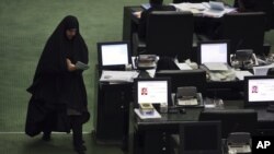 A lawmaker walks through the parliament in Tehran on August 17.