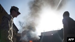 U.S. Marines burn human waste as they clean their lavatories at the Musa Qala base in the southern Helmand Province. Officials say the military is trying to reduce the incineration of solid waste, but many Afghans see little progress.