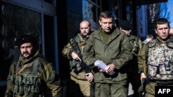 Separatist gunmen guard Aleksander Zakharchenko (center), prime minister of the self-proclaimed Donetsk People's Republic in Donetsk.