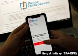 A woman examines Aleksei Navalny's Smart Voting app on her cellphone in Moscow on September 17.