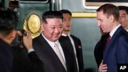 North Korean leader Kim Jong Un (center) is greeted by Russia's Natural Resources Minister Aleksandr Kozlov (right) after Kim crossed the border into Russia for a visit in September.