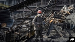 A worker clears the rubble at a power plant damaged in a Russian air strike in Ukraine in April. 