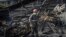 A worker clears the rubble at a power plant damaged in a Russian air strike in Ukraine in April. 