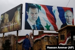 Портреты Башара Асада и Владимира Путина на улице сирийского города Алеппо