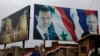 Posters of Syrian President Bashar Assad and Russian President Vladimir Putin in Aleppo, Syria, Thursday, Jan. 18, 2018