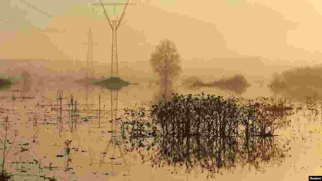 A pylon is reflected in floodwater near the village of Bogolyubovo, Russia, on April 26. (Reuters/Denis Sinyakov)