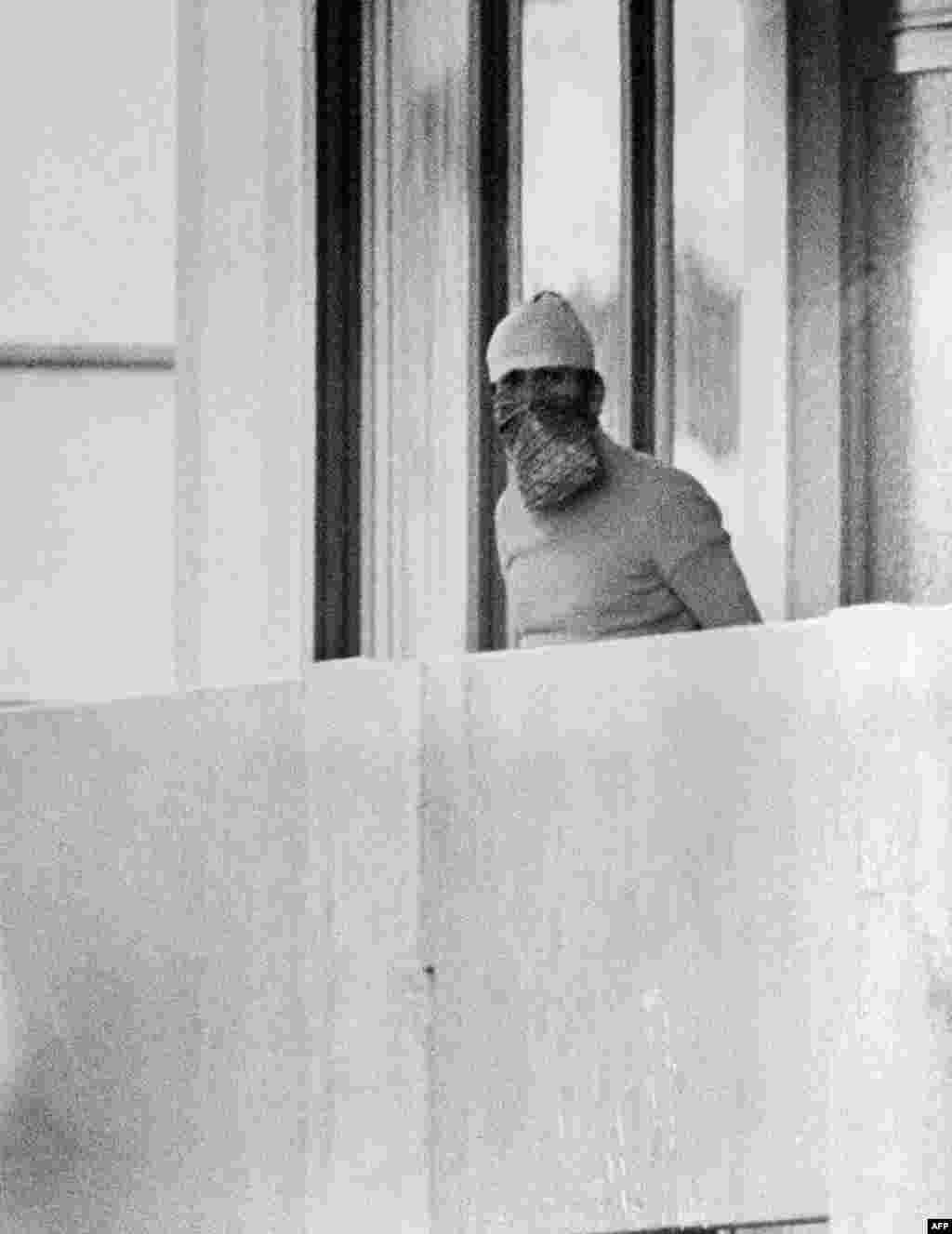 A Palestinian hostage taker appears on the balcony of an Israeli apartment at the Olympic village.