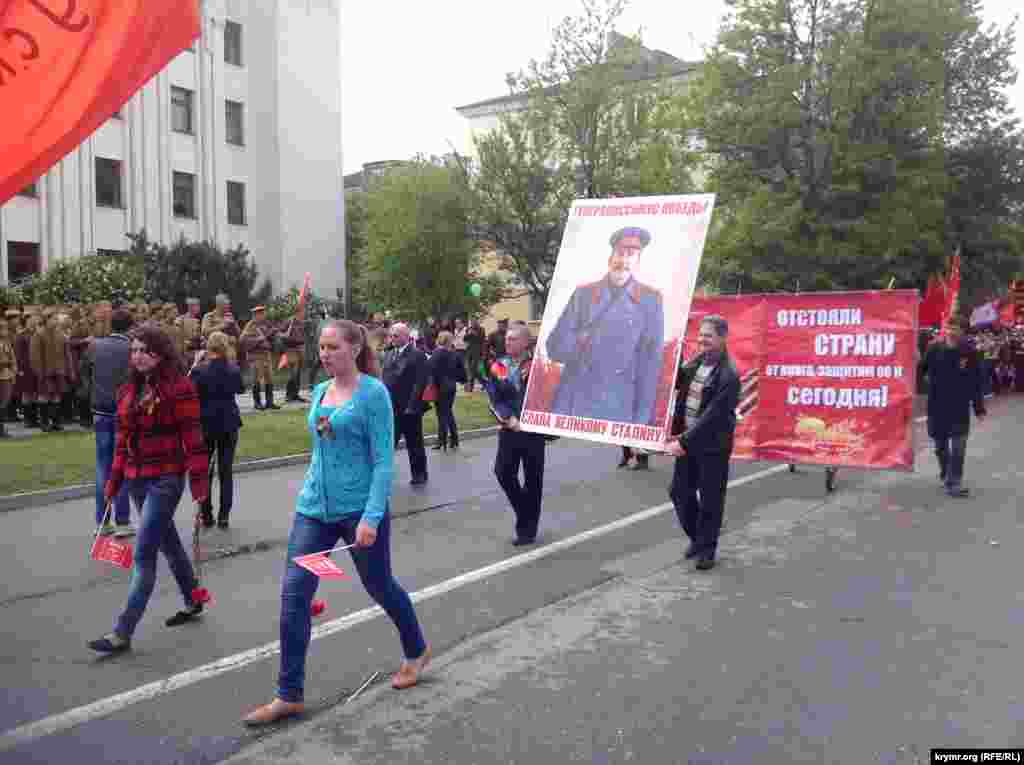 People carry a portrait of Stalin during a parade in Simferopol, Crimea.