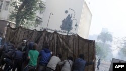 Egyptian protesters have used makeshift shields during clashes with security forces in Cairo.