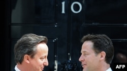 New Prime Minister David Cameron (left), a Conservative, speaks with new Deputy Prime Minister Nick Clegg, leader of the Liberal Democrats, outside 10 Downing Street in London on May 12.