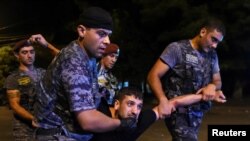 Armenia - Police officers detain a man during a clash with demonstrators who had gathered in a show of support for gunmen holding several hostages in a police station in Yerevan, Armenia, July 21, 2016