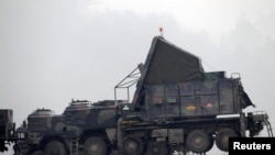 German military vehicles carrying equipment for NATO Patriot missiles at a military base in Kahramanmaras, Turkey