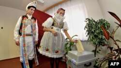 People wearing traditional costumes cast their votes at a polling station in Strazovice, in south Moravia.