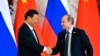 Russian President Vladimir Putin (right) shakes hands with his Chinese counterpart Xi Jinping in Moscow on May 8. 