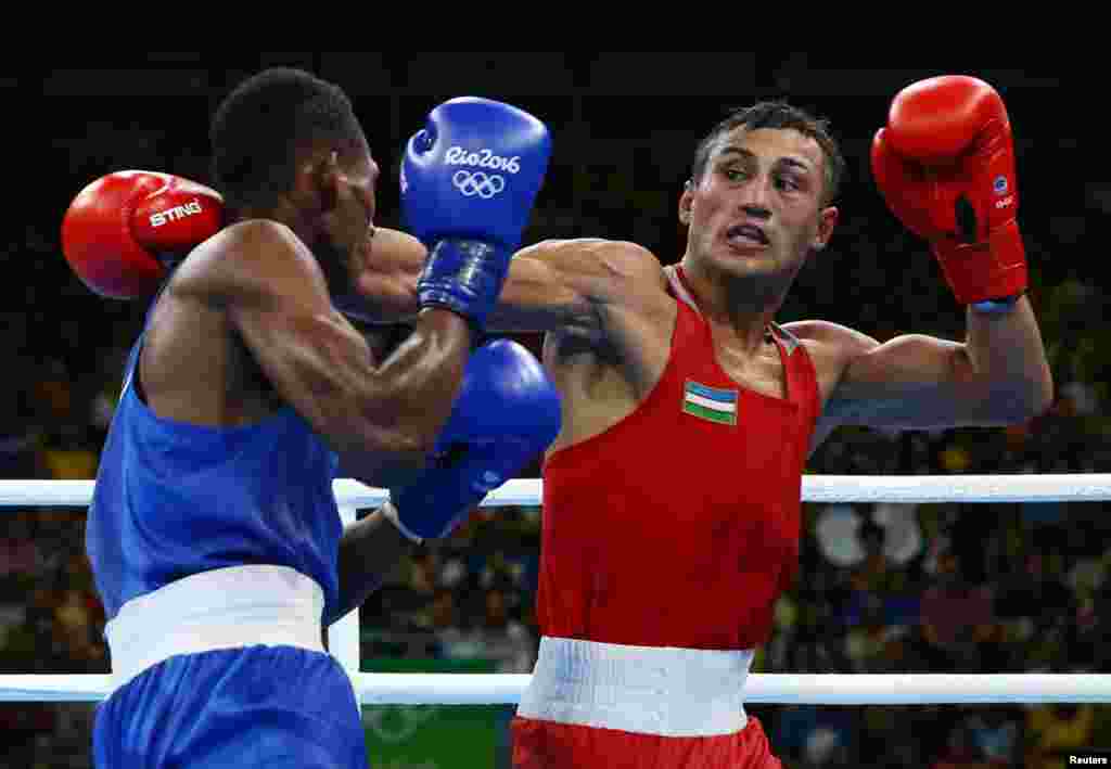 Fazliddin Gaibnazarov of Uzbekistan (in red) defeated Cuban-born Lorenzo Sotomayor Collazo, representing Azerbaijan, in the light welterweight final. Russia's Vitaly Dunaytsev won bronze.