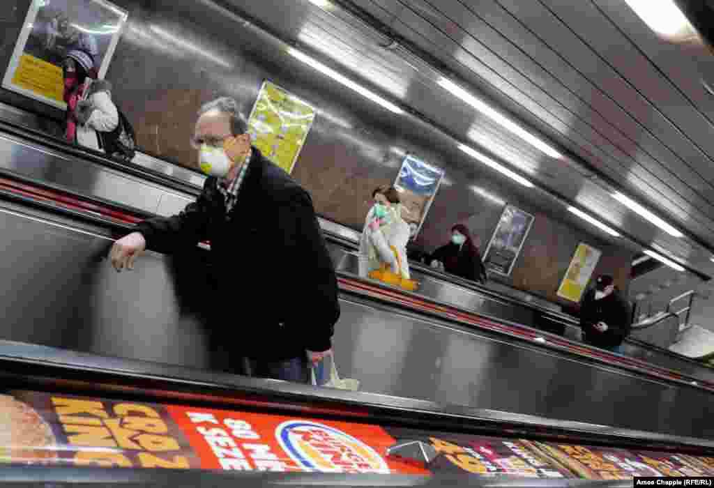 Commuters wearing masks ascend an escalator on March 17.&nbsp;