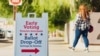 (FILES) People walk to cast their ballot during early voting in the US presidential election at Recorder's Main Office, in Tucson, Arizona, on October 16, 2024.