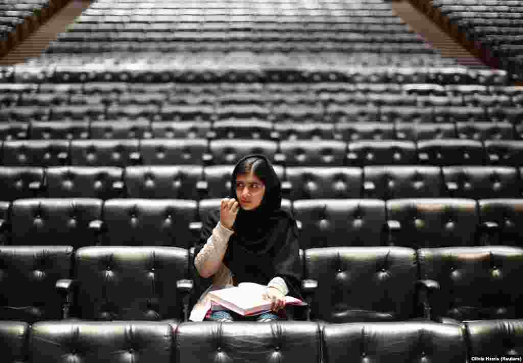 Pakistani teenage activist Malala Yousafzai signs a copy of her book before an event launching her memoir, I Am Malala, at the Southbank Centre in central London, October 20, 2013. (Reuters/Olivia Harris)