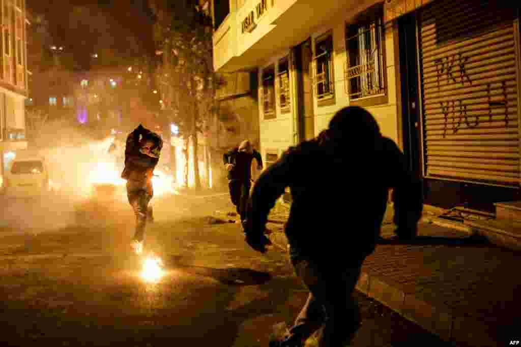 A protester prepares to throw a Molotov cocktail at Turkish police during a demonstration against government-imposed curfews imposed on areas of eastern Turkey. (AFP/Yasin Akgul)