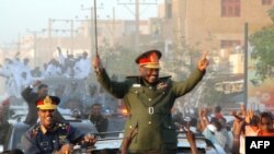 Sudanese President Omar al-Bashir parades in the streets of Khartoum in March 2009.