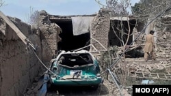 A man inspects damaged houses near the site where a suicide bomber detonated explosives in a truck in the northren province of Balkh on August 25.