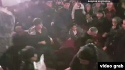 A video recording by a witness shows a group of mostly young men throwing punches at each other, and grabbing and pulling each other’s jackets. 