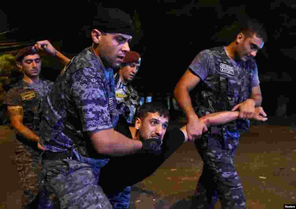 Armenia - Police officers detain a man during a clash with demonstrators who had gathered in a show of support for gunmen holding several hostages in a police station in Yerevan, Armenia, July 21, 2016