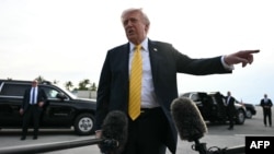US President Donald Trump speaks to reporters before a flight to Miami from West Palm Beach, Florida.