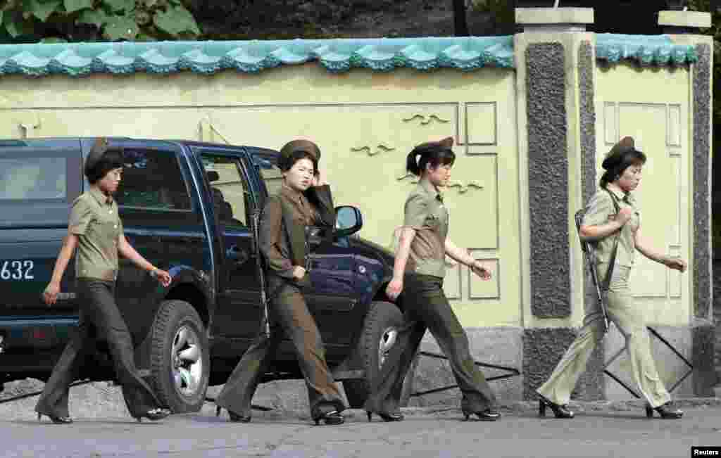 Female North Korean soldiers walk along the banks of the Yalu River near the North Korean town of Sinuiju, opposite the Chinese border city of Dandong on June 23. (Reuters/Jacky Cheng)