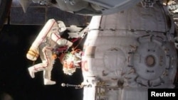 Russian cosmonaut Oleg Kononenko conducts a space walk outside the ISS on December 11.