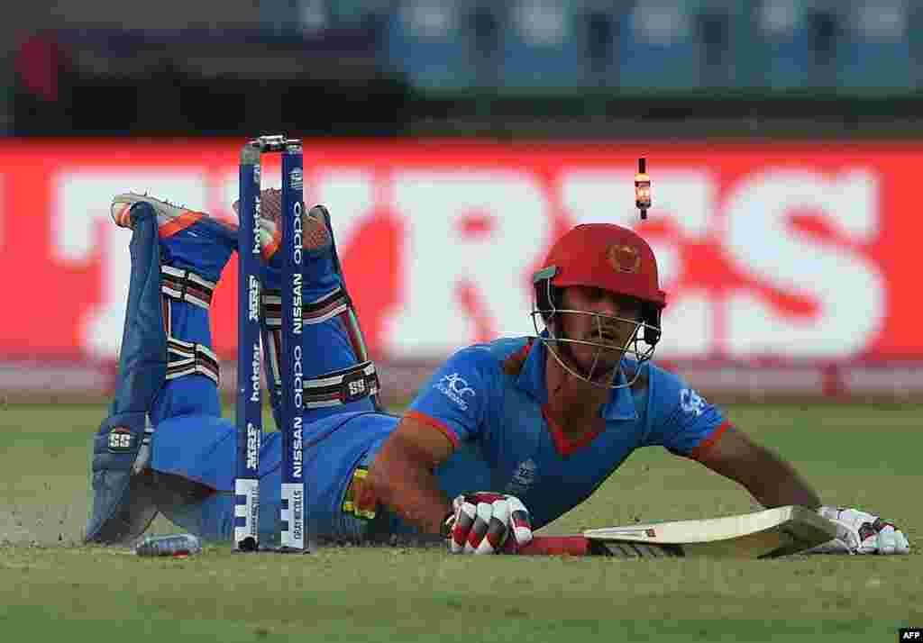 Afghanistan&#39;s Najibullah Zadran makes his ground successfully after a run-out while batting against England at the Feroz Shah Kolta Cricket Stadium in New Delhi on March 23.