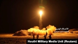 A photo distributed by the Houthi Military Media Unit shows the launch by Houthi forces of a ballistic missile aimed at Saudi Arabia, March 25, 2018