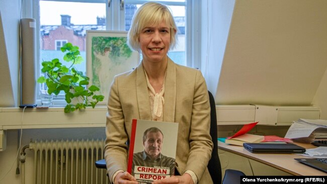 Депутат парламента Швеции Мария Нильссон в своем офисе в Стокгольме с книгой журналиста Николая Семены «Крымский репортаж»