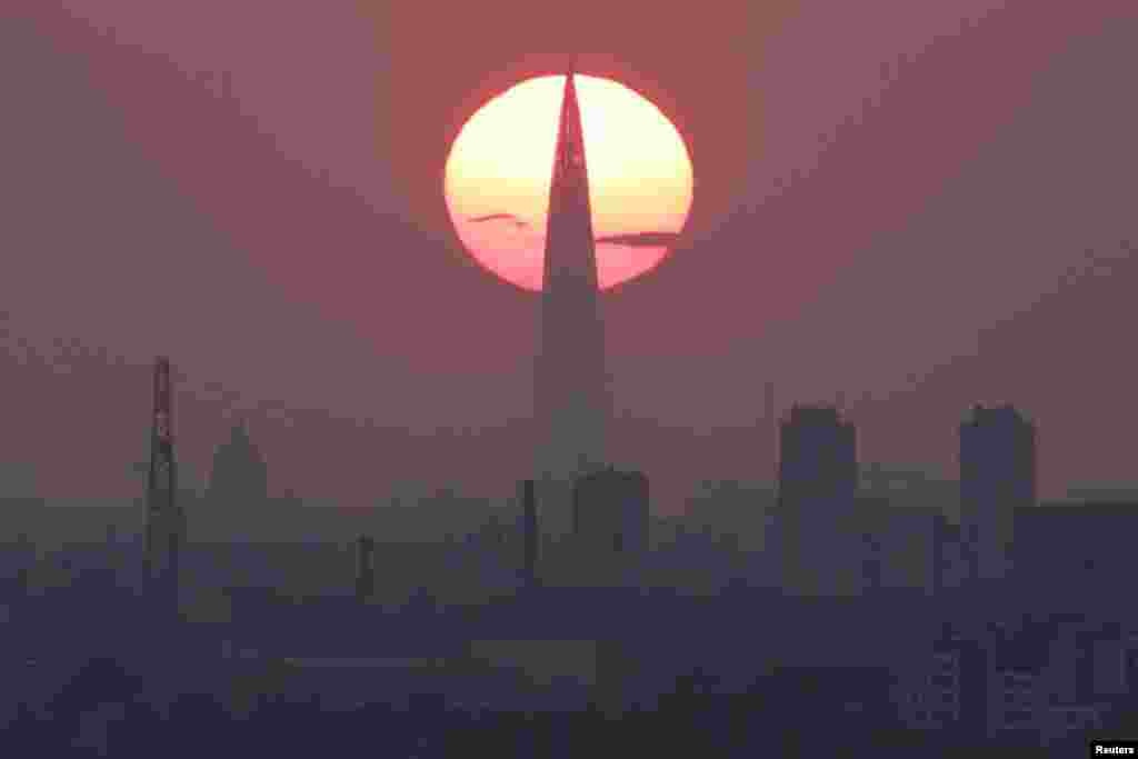 The sun sets behind the Lakhta Center business tower on a hot day in St. Petersburg, Russia.