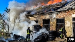 Ukrainian firefighters battler a blaze following Russian shelling on Kherson earlier this month. 