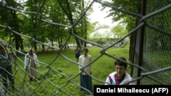 Female residents of a maximum-security psychiatric hospital look through a fence in Romania, where a lack of understanding and discrimination against people with mental illness is still rife. (illustrative photo)