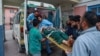 An injured woman living in a village near the Line of Control between India and Pakistan in Kashmir is brought to a hospital following shelling by Pakistan on May 7. 