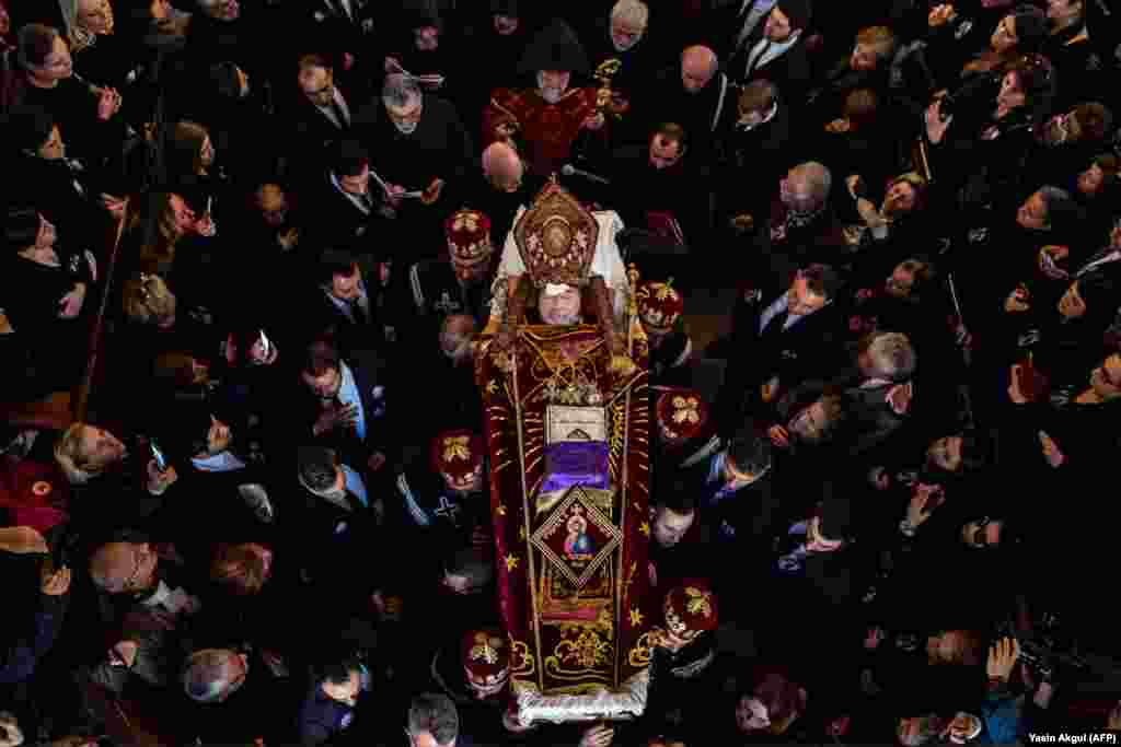 People gather and mourn next to the coffin of the late Armenian Patriarch in Turkey, Mesrob Mutafyan, in Istanbul. (AFP/Yasin Akgul)