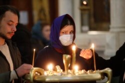 Georgian Orthodox believers light candles during a religious service in Tbilisi earlier this month.