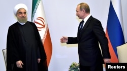 Russian President Vladimir Putin (right) and Iranian leader Hassan Rohani during a 2016 meeting in Baku