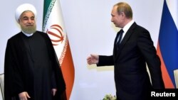 Russian President Vladimir Putin (right) greets Iranian President Hassan Rohani during a meeting in Baku in August 2016.