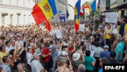 Moldovans protest in front of the headquarters of the Democratic Party after the invalidation of the mayoral election in Chisinau on June 20.