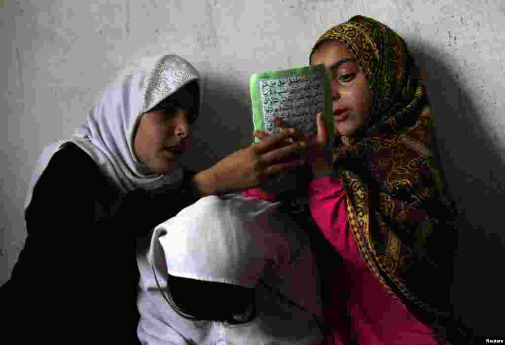 Afghan children read the Koran in a madrasah, or religious school, during the Muslim holy month of Ramadan in Kabul on June 30. (Reuters/Mohammad Ismail)