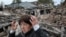 A woman stands at the site of her relatives' house, which was destroyed during a Russian air strike on the outskirts of Dnipro, Ukraine, on October 19.